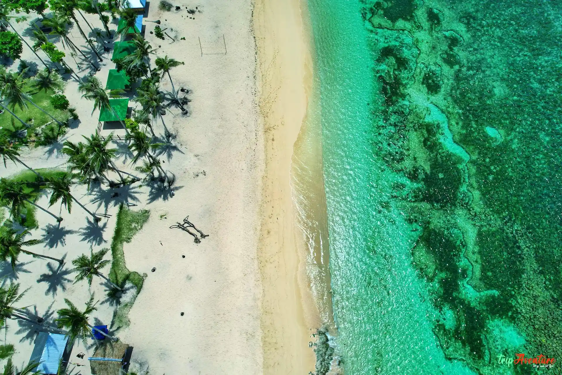 Calm, shallow turquoise water at Alegria Beach in Santa Monica, Siargao