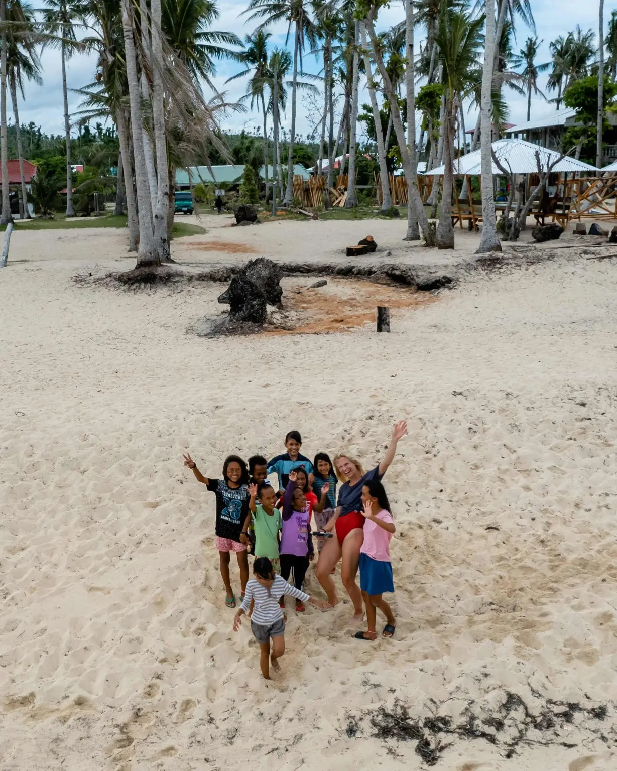 Filipino families relaxing at Alegria Beach, Santa Monica, Siargao Island, Philippines on a weekend afternoon