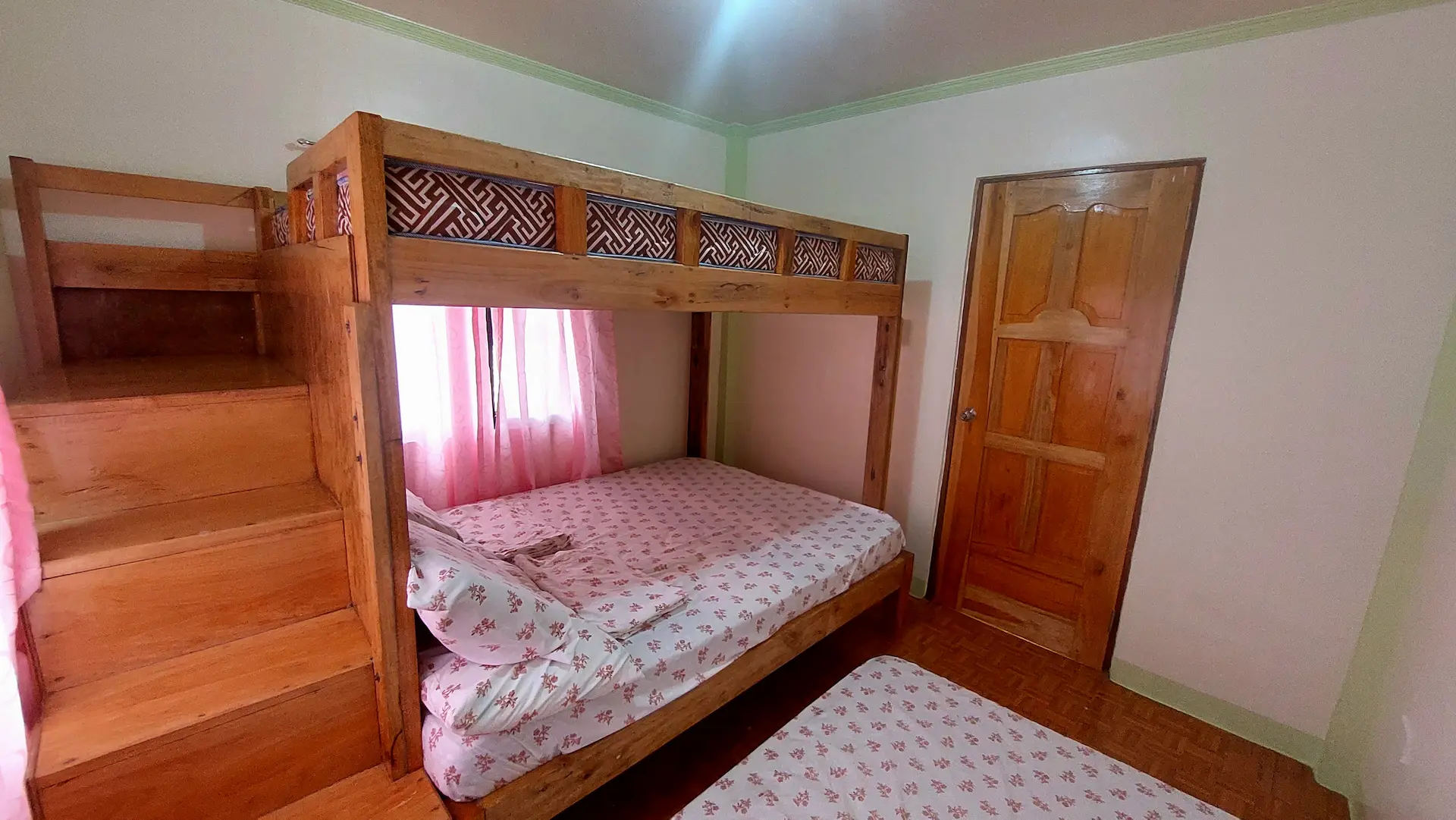 Snug Family Room double bed with clean white linens and ceiling fan